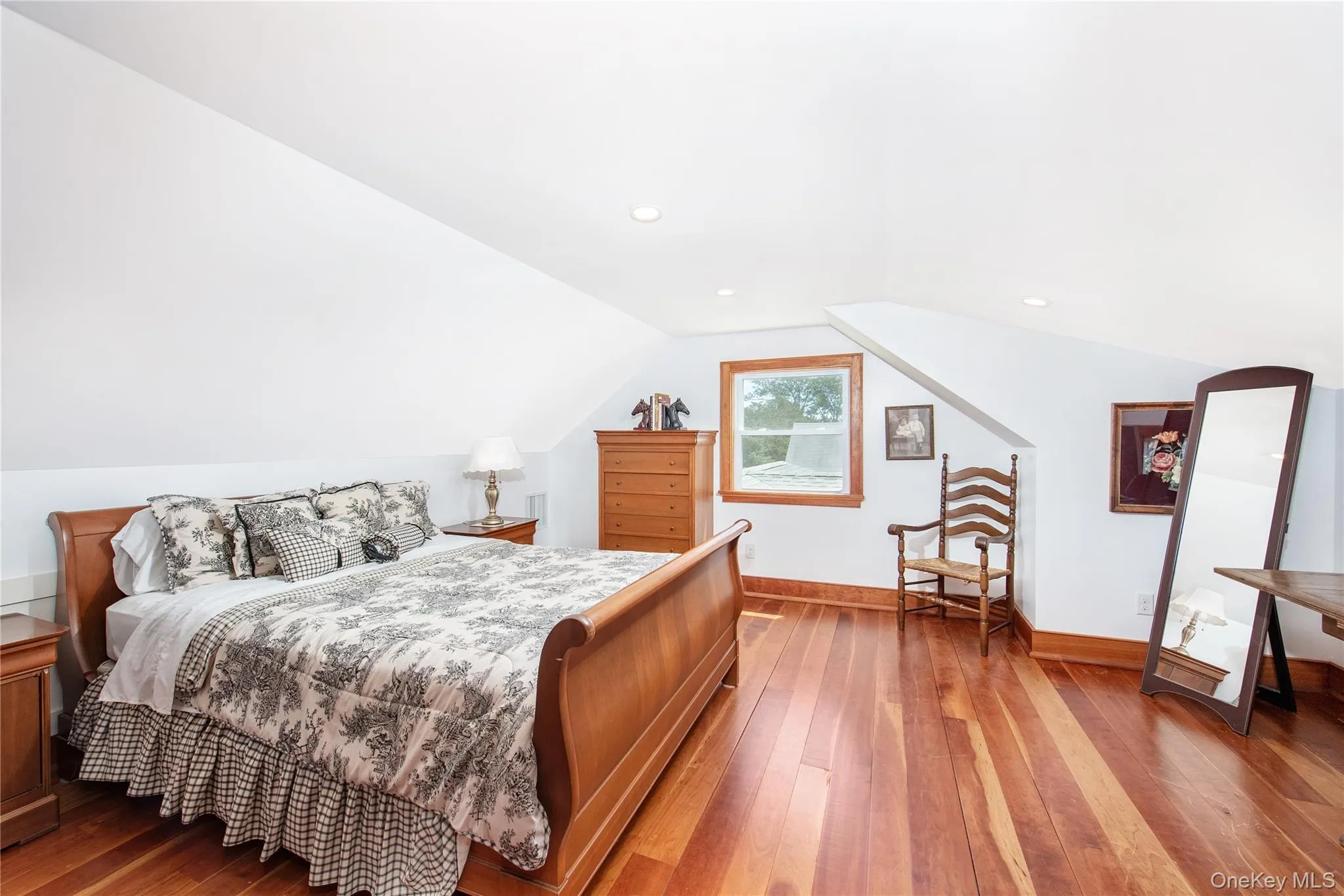 Bedroom with hardwood / wood-style flooring and lofted ceiling Bedroom with hardwood / wood-style flooring and lofted ceiling