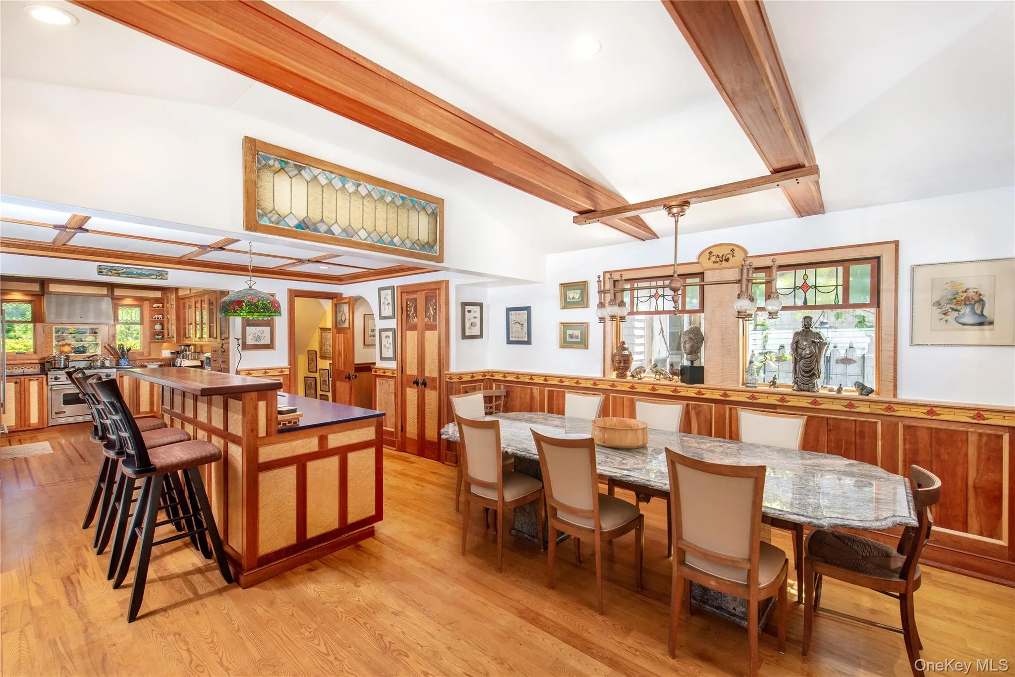 Dining area with light wood finished floors, arched walkways, a wainscoted wall, and recessed lighting Dining area with light wood finished floors, arched walkways, a wainscoted wall, and recessed lighting