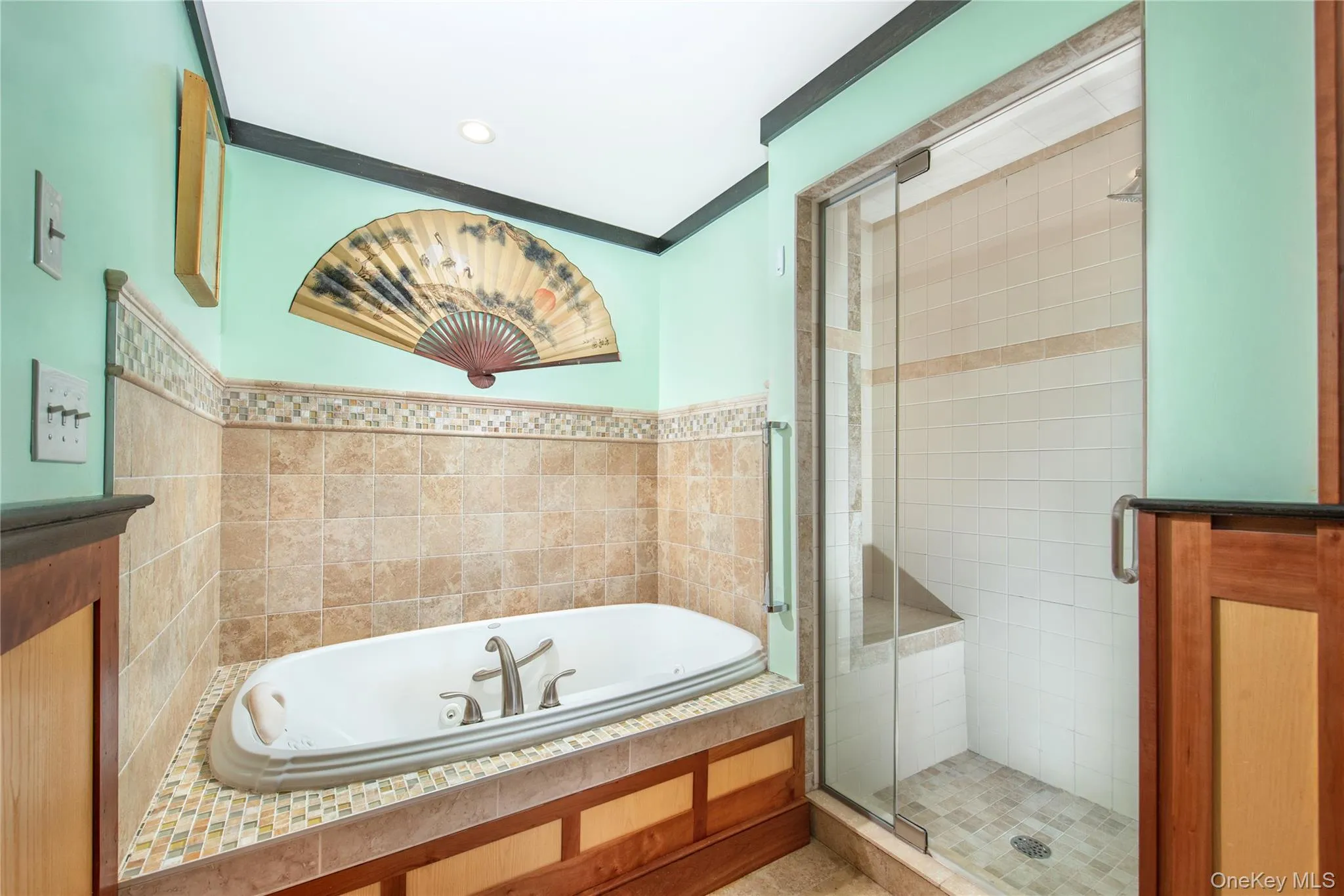 Bathroom with a bath, a shower stall, ornamental molding, and recessed lighting Bathroom with a bath, a shower stall, ornamental molding, and recessed lighting