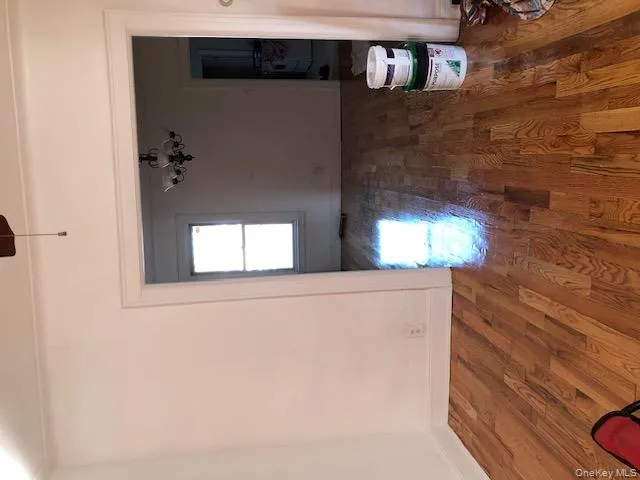 Unfurnished dining area featuring a chandelier, dark wood finished floors, and washer / clothes dryer Unfurnished dining area featuring a chandelier, dark wood finished floors, and washer / clothes dryer
