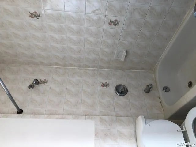 Full bath featuring bathing tub / shower combination and toilet Full bath featuring bathing tub / shower combination and toilet