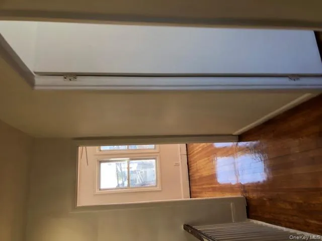 Hall with dark wood finished floors and baseboards Hall with dark wood finished floors and baseboards