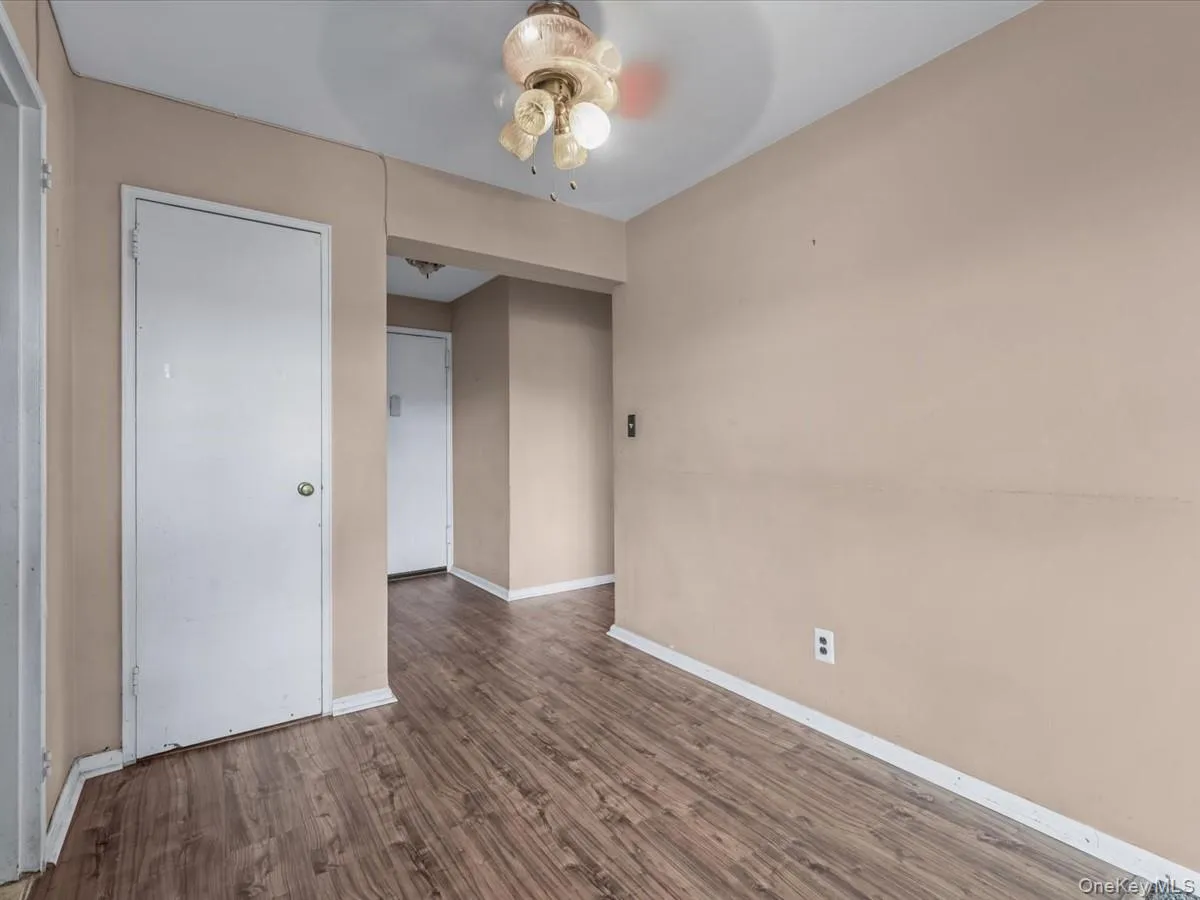 Unfurnished bedroom featuring wood finished floors and a ceiling fan Unfurnished bedroom featuring wood finished floors and a ceiling fan