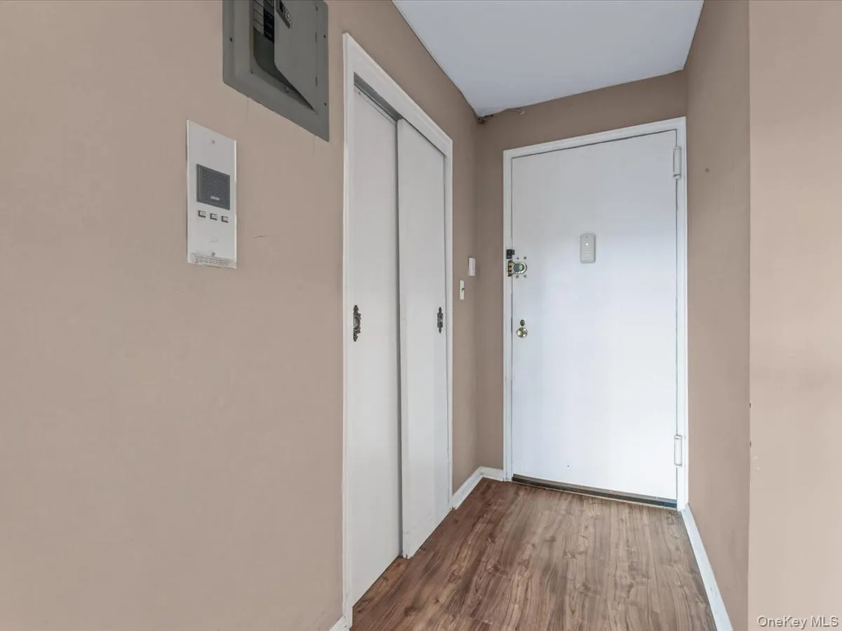Hallway with electric panel and wood finished floors Hallway with electric panel and wood finished floors