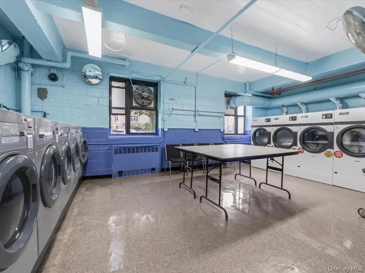 Shared laundry featuring independent washer and dryer and radiator heating unit Shared laundry featuring independent washer and dryer and radiator heating unit