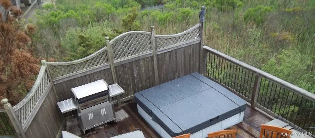 Wooden deck with a covered hot tub Wooden deck with a covered hot tub