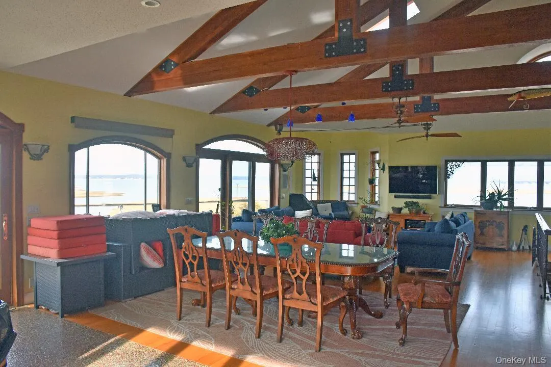 Dining space featuring a water view and wood finished floors Dining space featuring a water view and wood finished floors