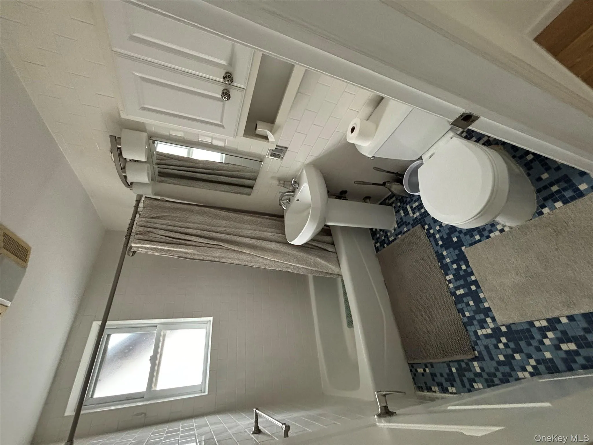 Full bath featuring shower / tub combo with curtain and tile walls Full bath featuring shower / tub combo with curtain and tile walls