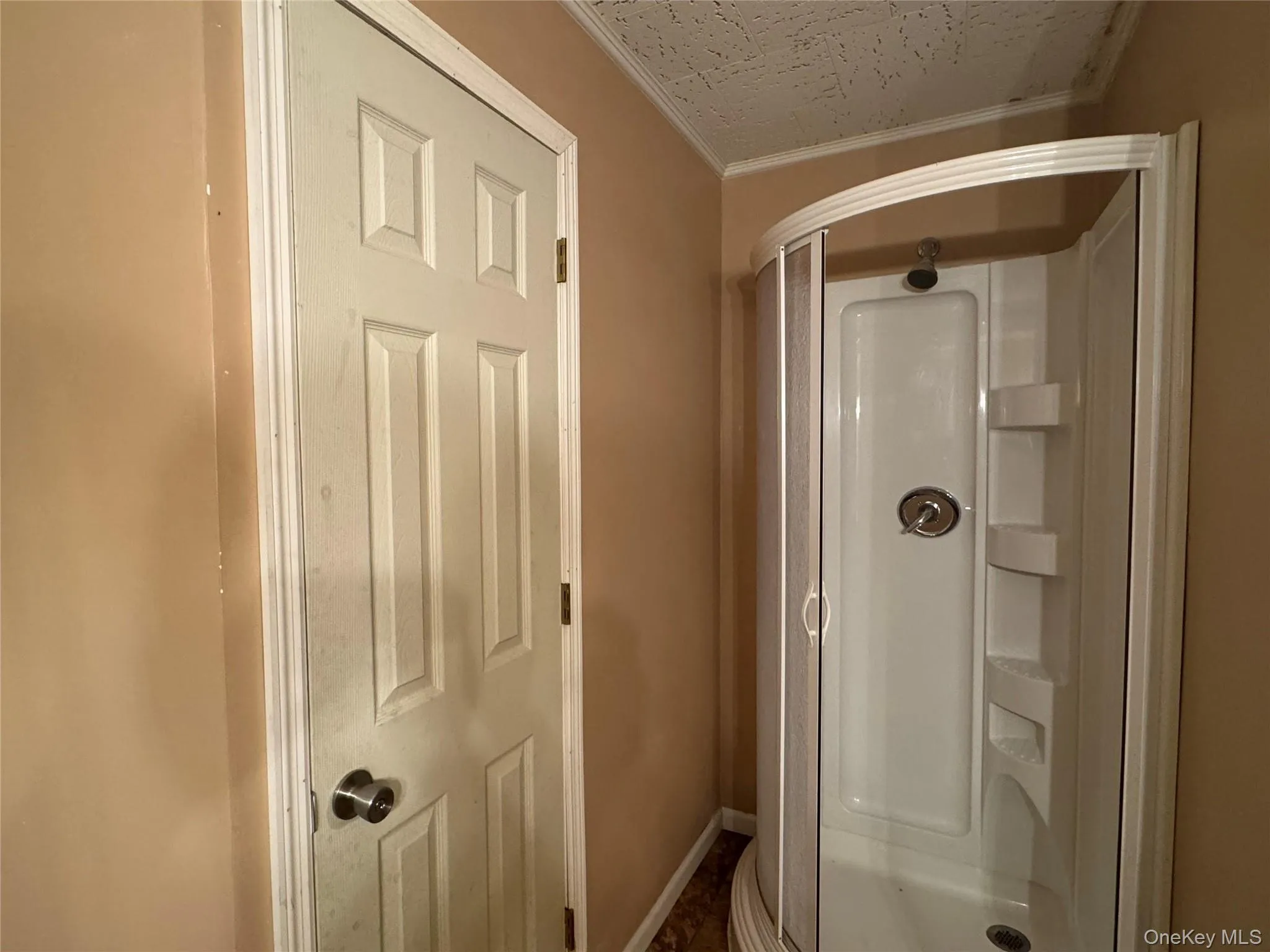 Full bathroom with crown molding and a shower stall Full bathroom with crown molding and a shower stall