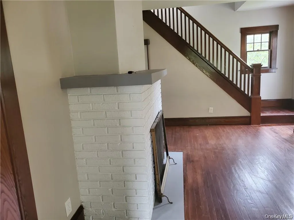 Staircase with hardwood and fireplace Staircase with hardwood and fireplace