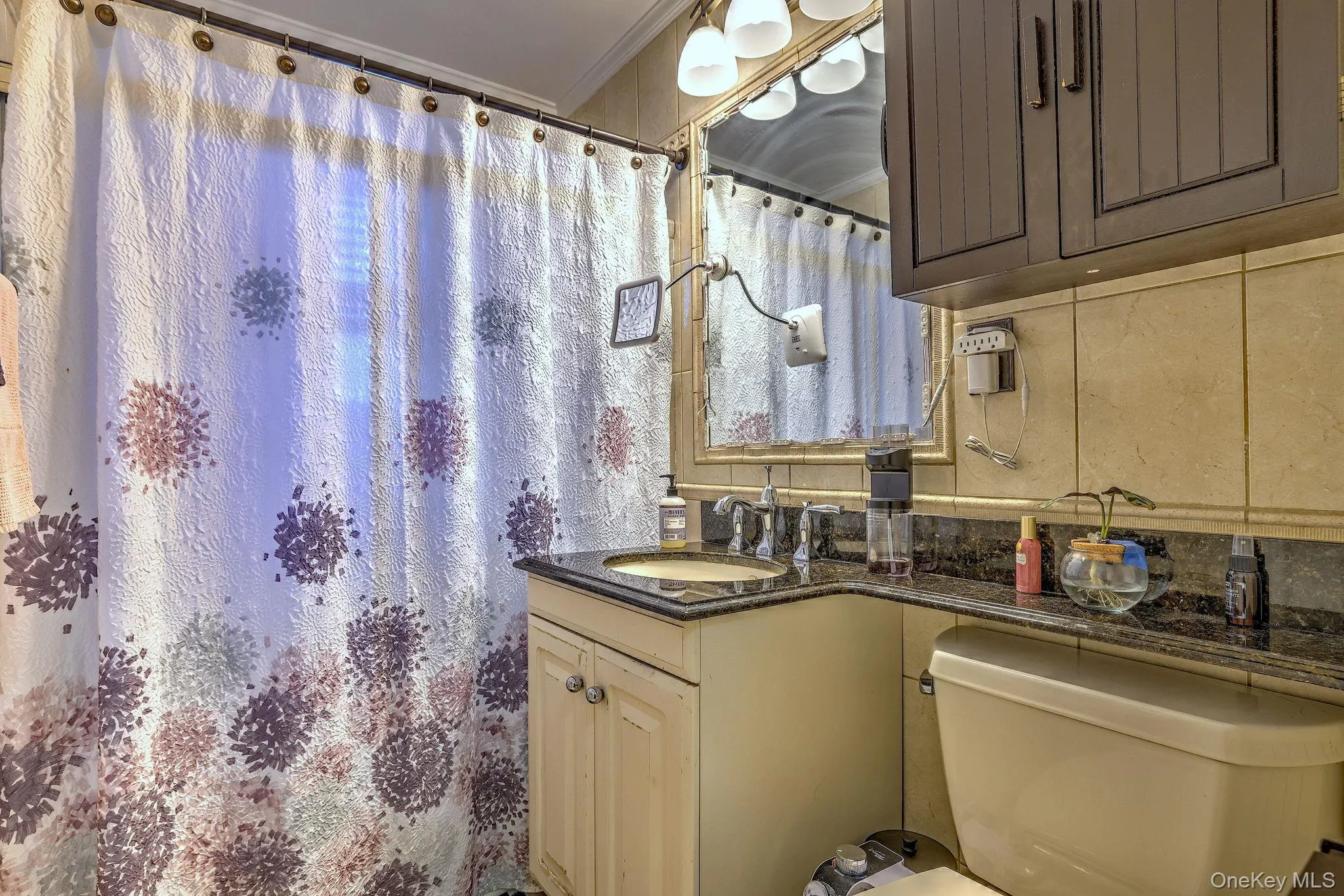 Bathroom with curtained shower, ornamental molding, and vanity Bathroom with curtained shower, ornamental molding, and vanity