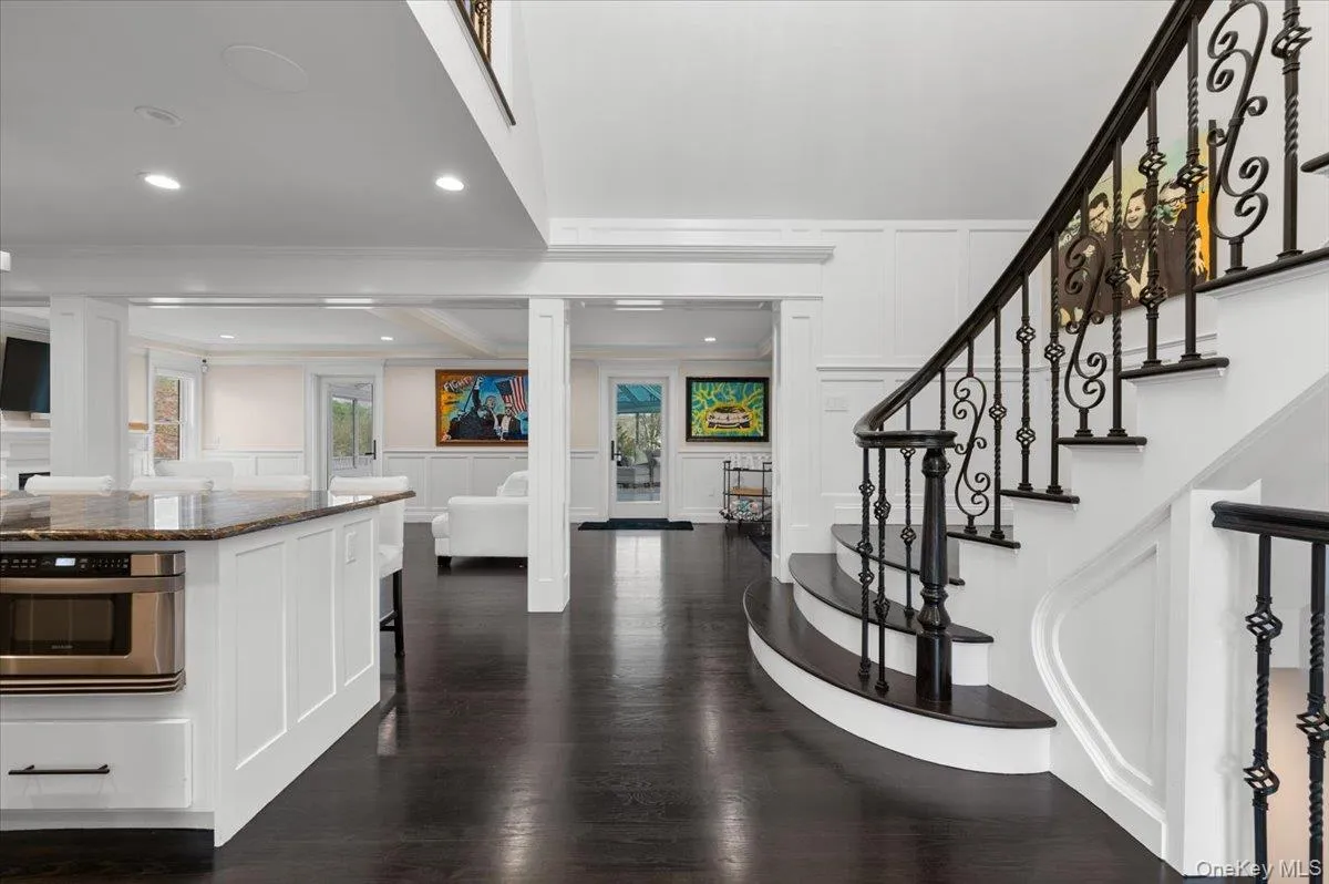 Entrance foyer featuring a decorative wall, dark wood-style floors, wainscoting, crown molding, and recessed lighting Entrance foyer featuring a decorative wall, dark wood-style floors, wainscoting, crown molding, and recessed lighting