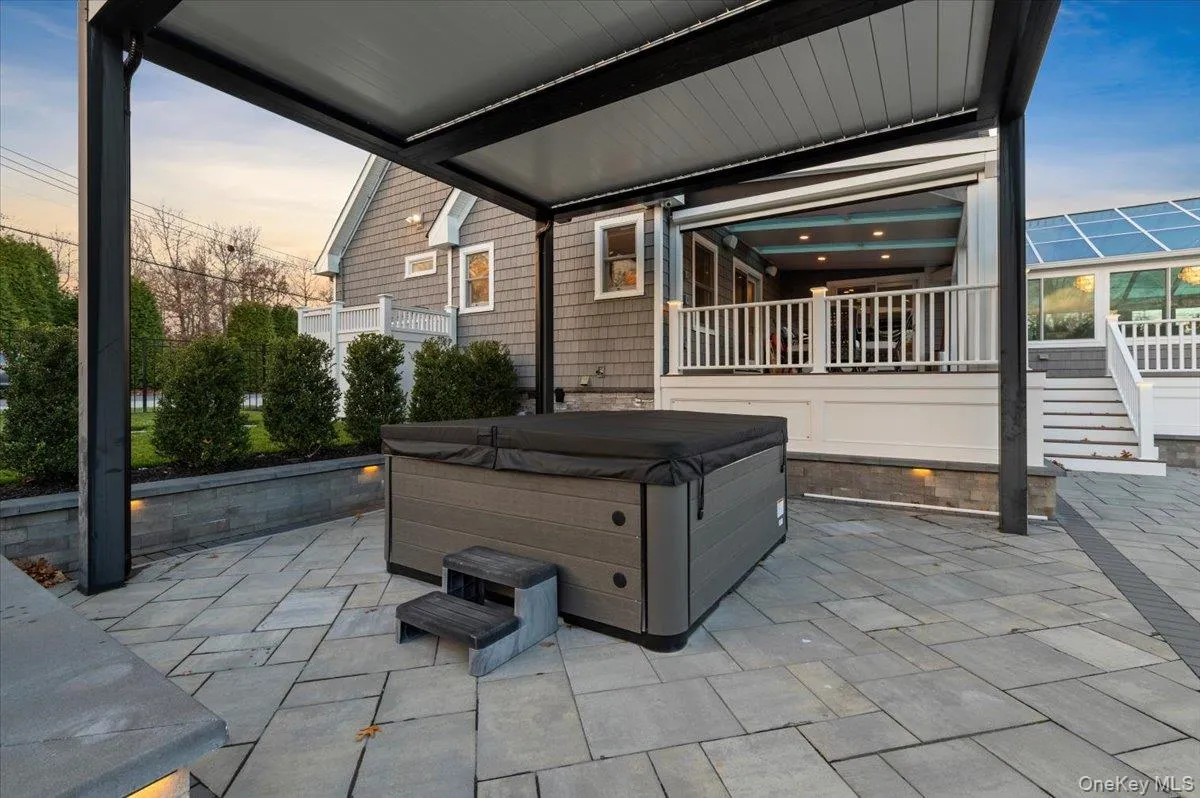 View of patio with a hot tub View of patio with a hot tub