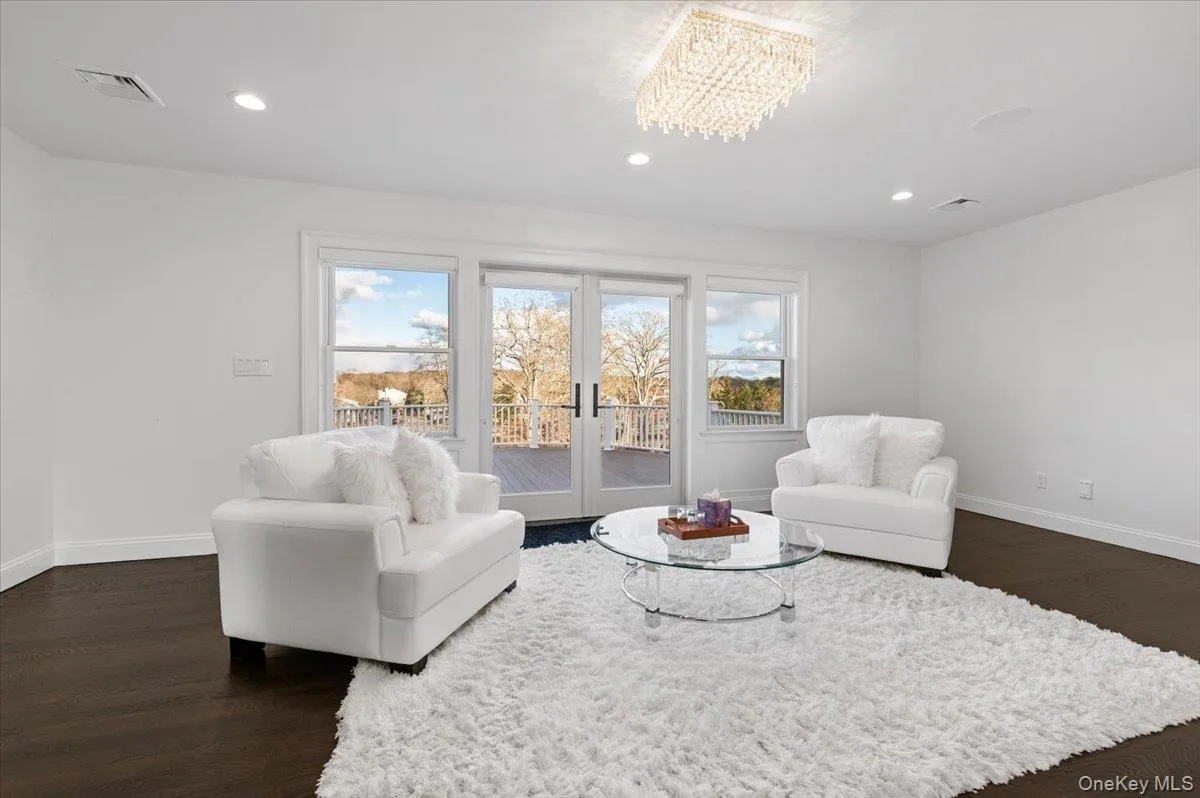 Sitting room featuring recessed lighting, dark wood finished floors, and french doors Sitting room featuring recessed lighting, dark wood finished floors, and french doors