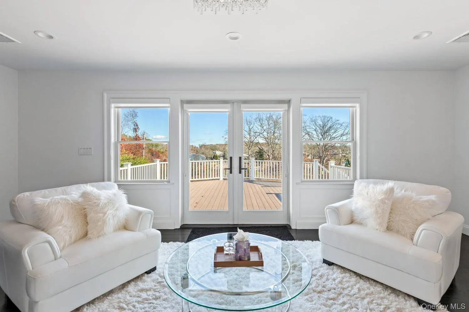 Living area with recessed lighting and wood finished floors Living area with recessed lighting and wood finished floors