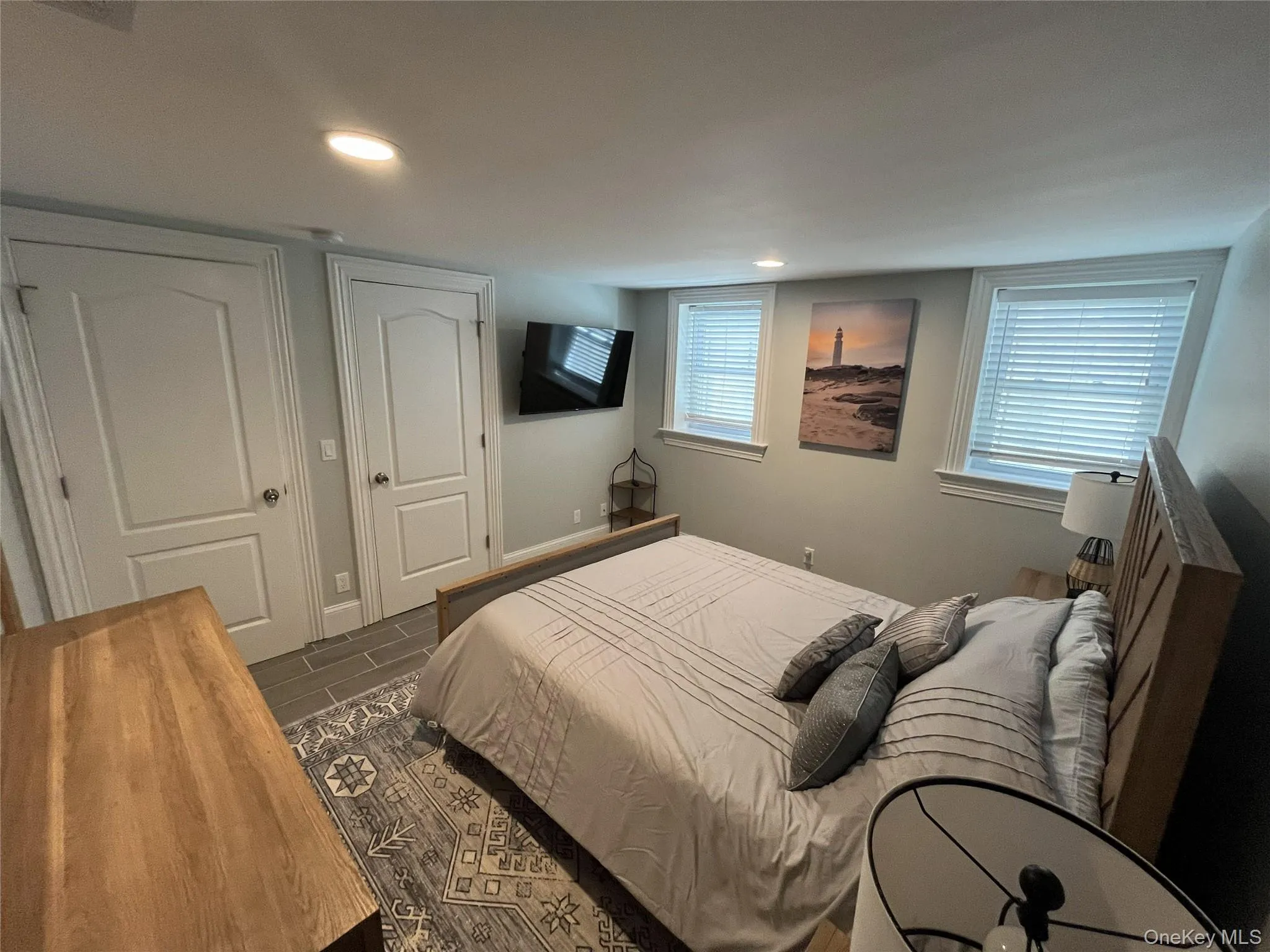 Bedroom featuring wood finish floors, recessed lighting, and a closet Bedroom featuring wood finish floors, recessed lighting, and a closet