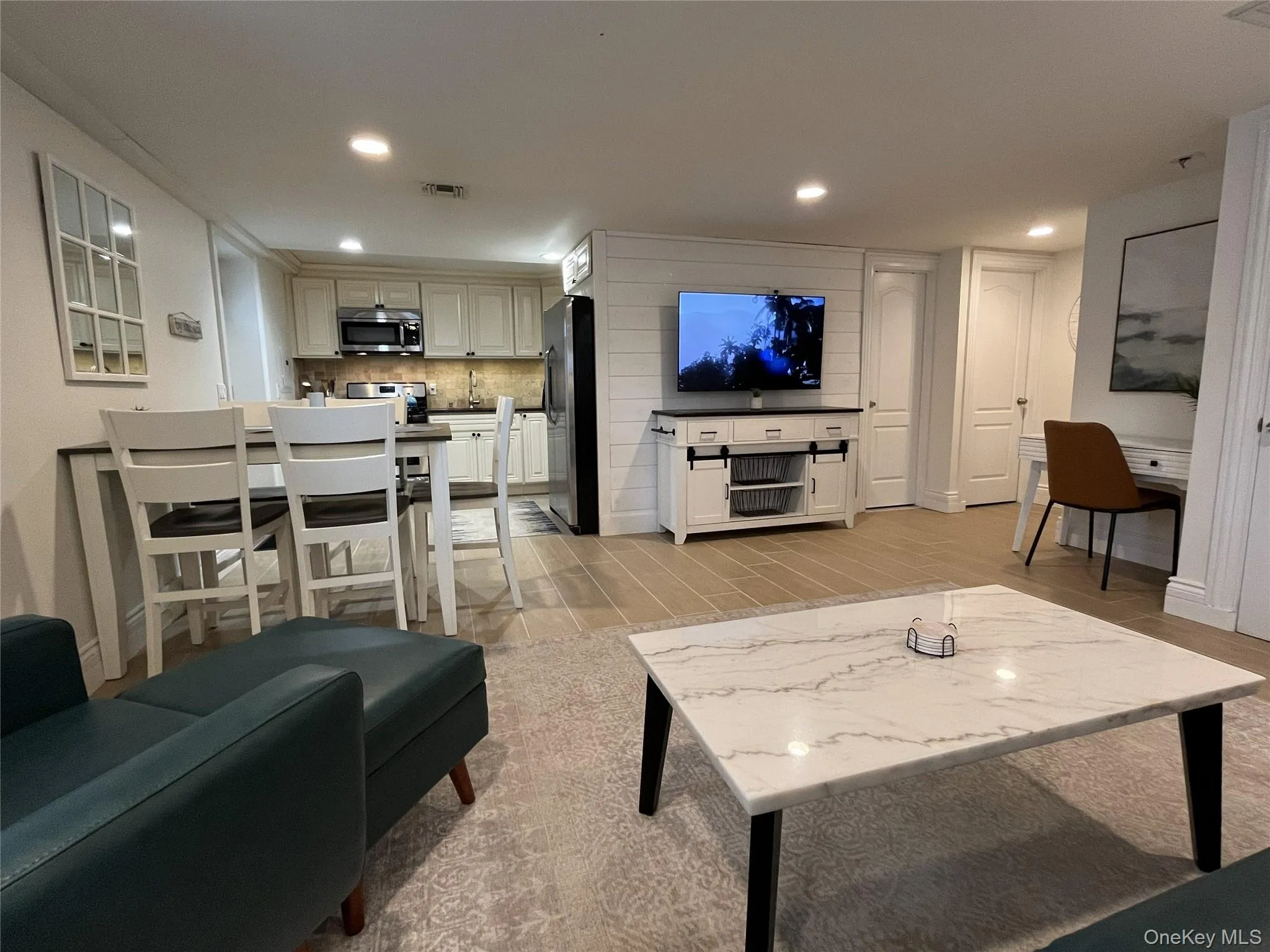 Living area with wood finish floors and recessed lighting Living area with wood finish floors and recessed lighting