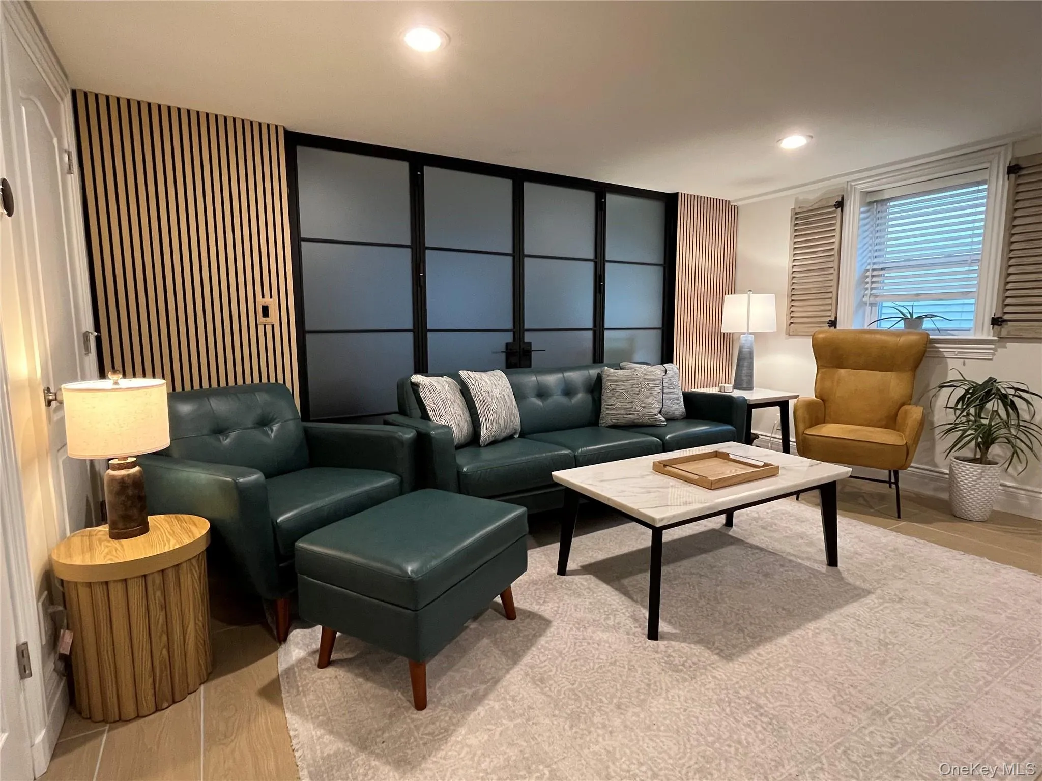 Living room featuring light wood-style flooring and recessed lighting Living room featuring light wood-style flooring and recessed lighting