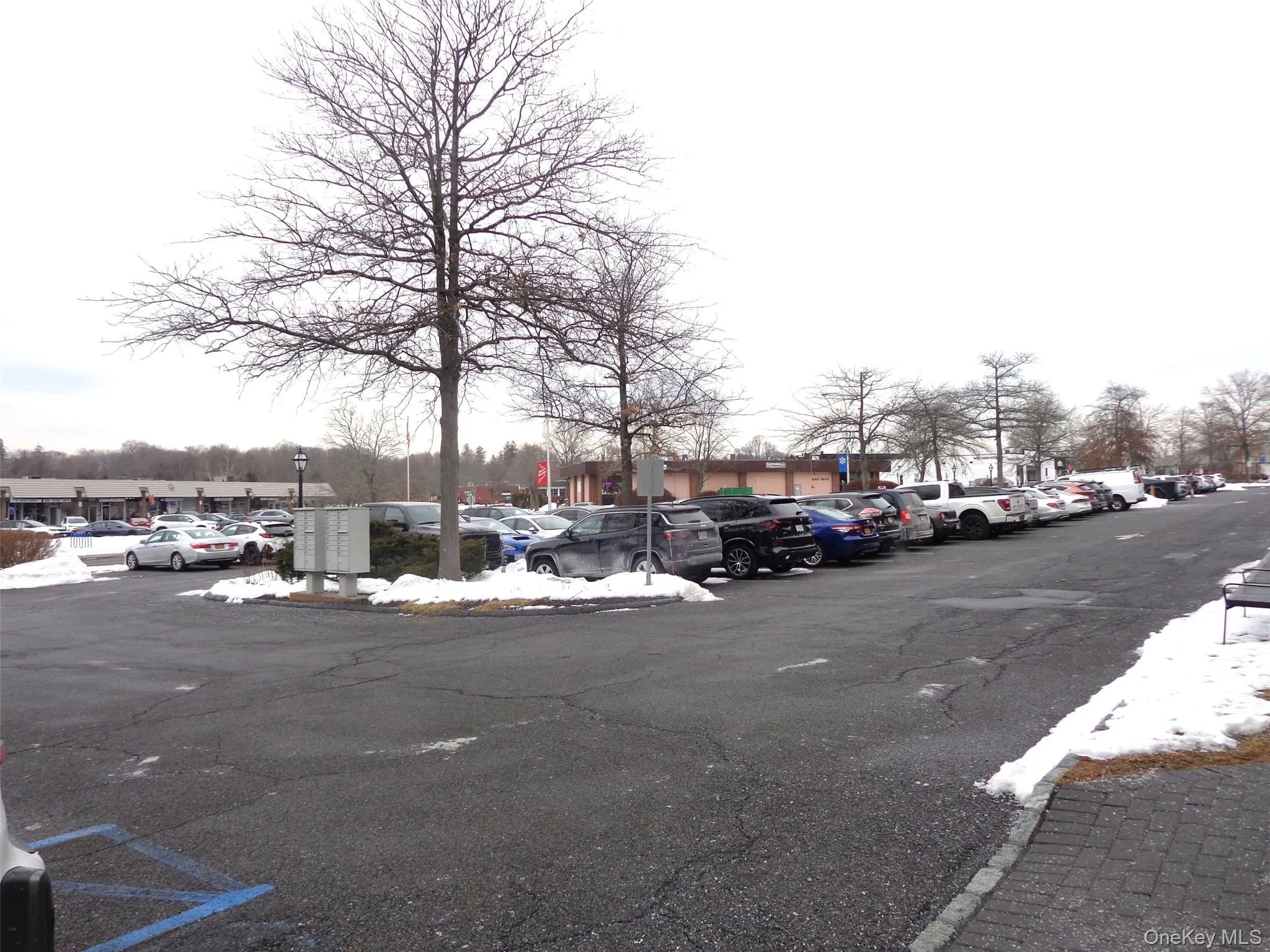 View of parking lot for your vehicle. Note variety of stores in the background. View of parking lot for your vehicle. Note variety of stores in the background.