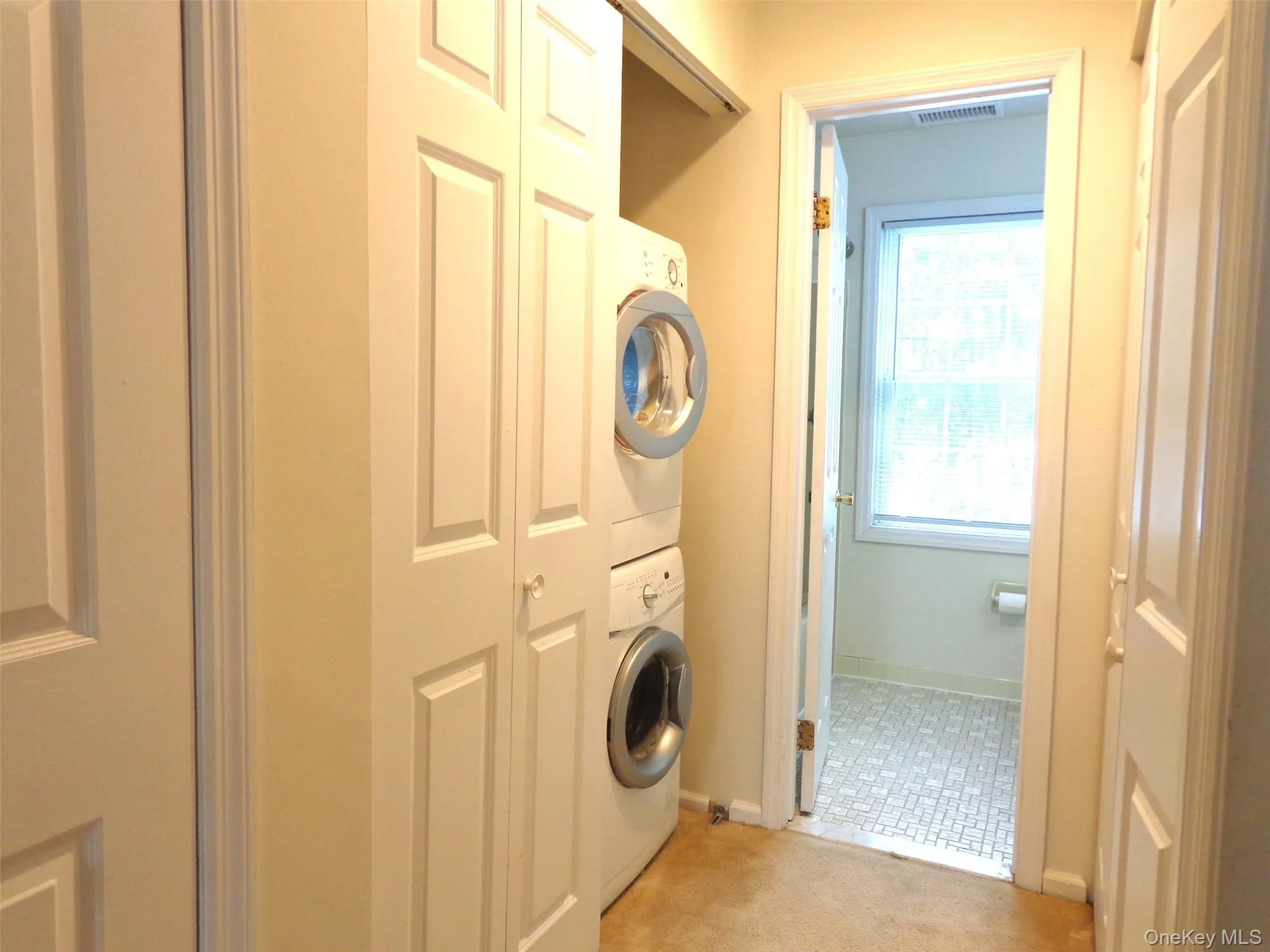Closet next to stacked washer/dryer is perfect for laundry supplies, etc. Closet next to stacked washer/dryer is perfect for laundry supplies, etc.