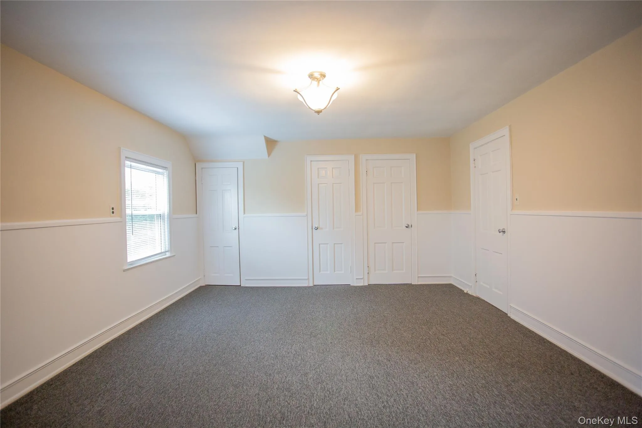 Unfurnished bedroom with carpet flooring and baseboards Unfurnished bedroom with carpet flooring and baseboards
