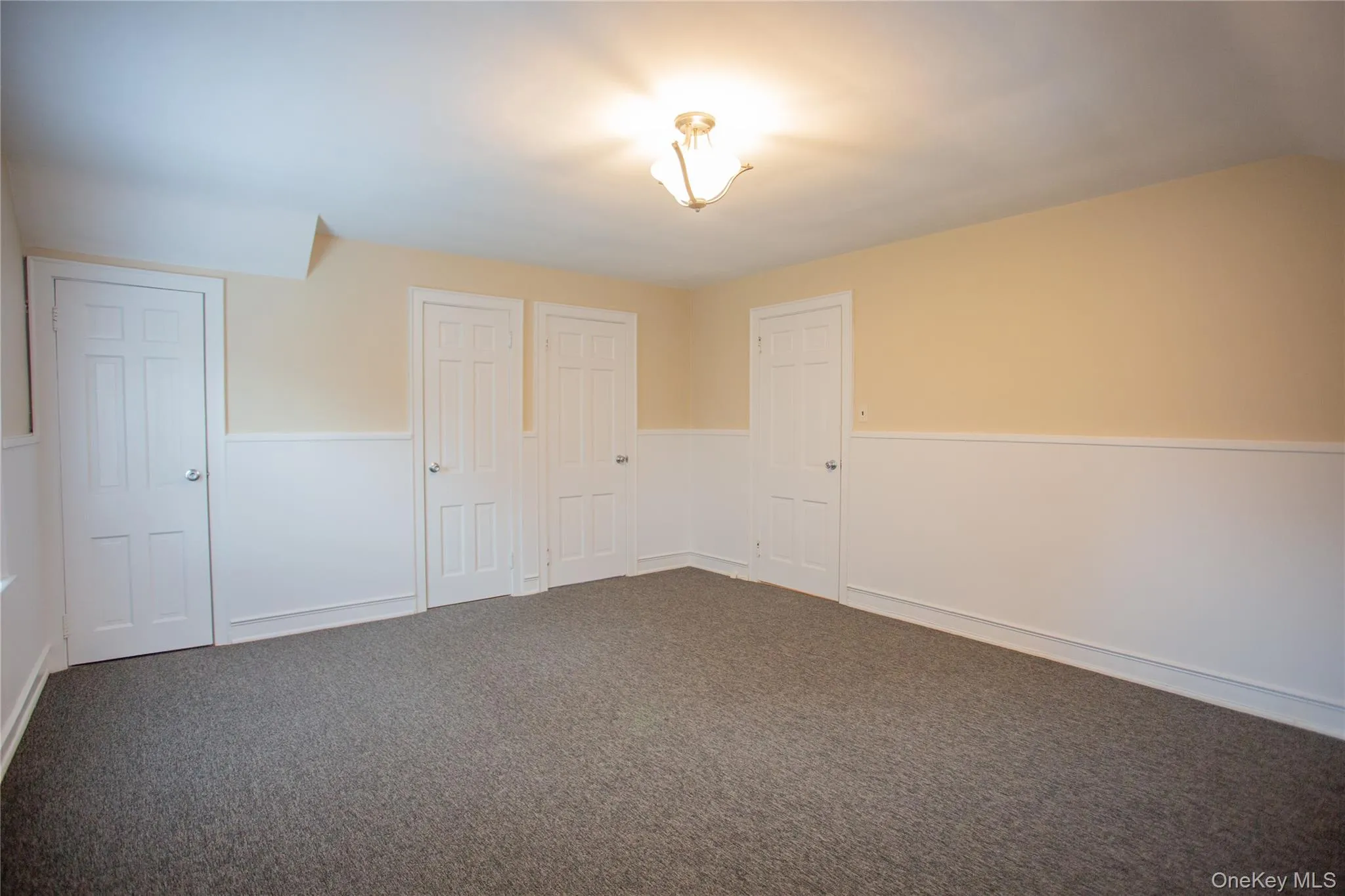 Unfurnished bedroom featuring carpet flooring Unfurnished bedroom featuring carpet flooring