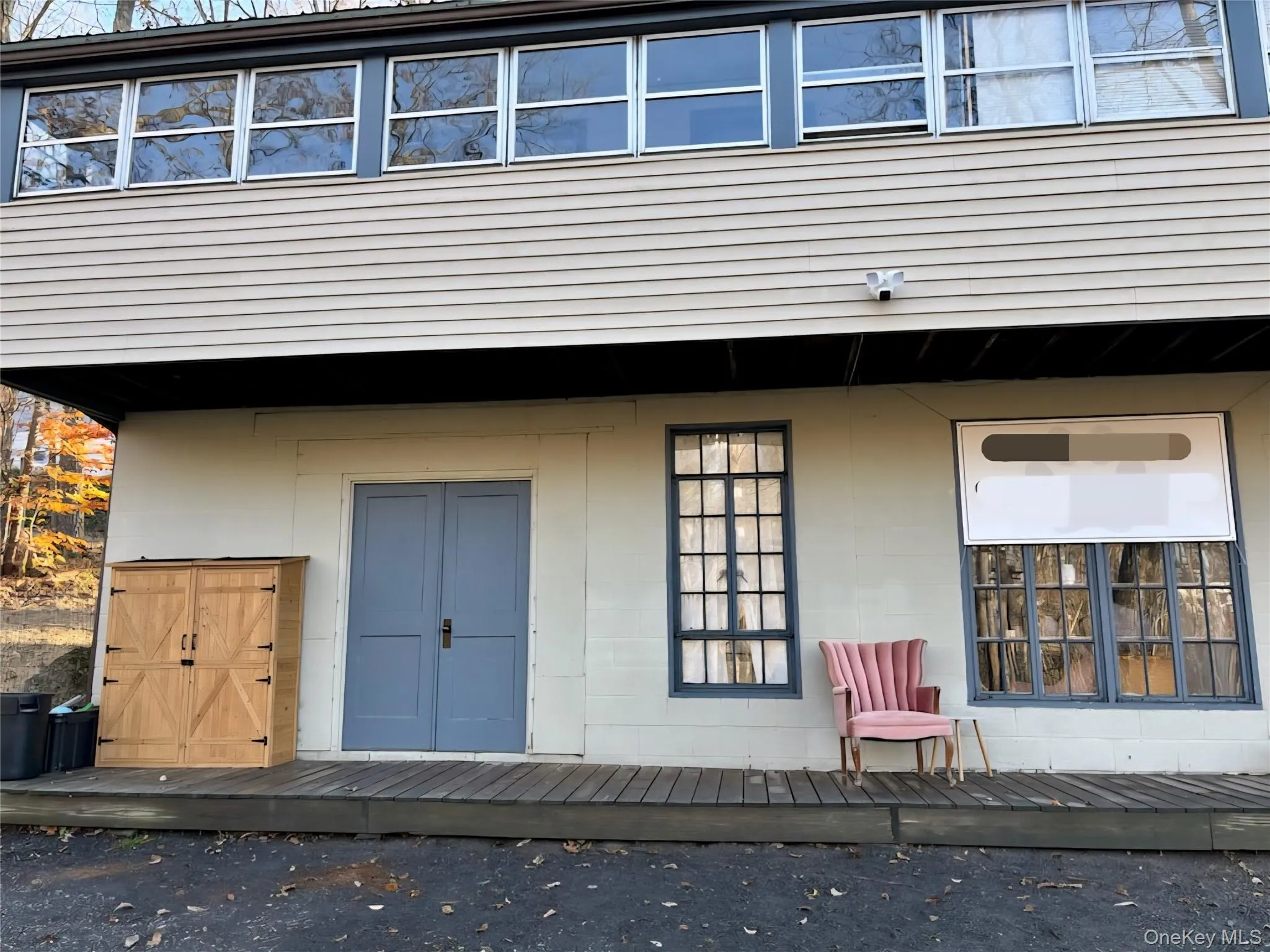 Doorway to property featuring a deck and concrete block siding Doorway to property featuring a deck and concrete block siding