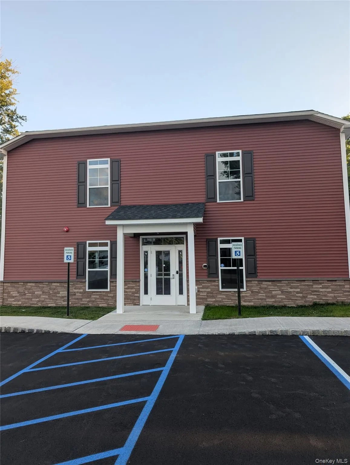 View of clubhouse featuring uncovered parking View of clubhouse featuring uncovered parking