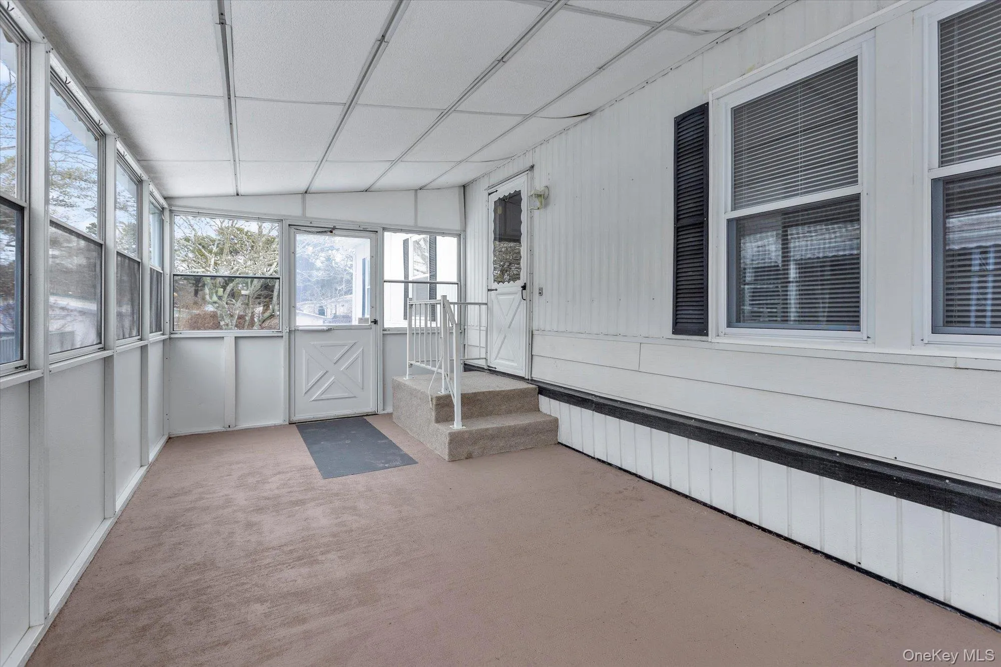 Unfurnished sunroom with lofted ceiling Unfurnished sunroom with lofted ceiling