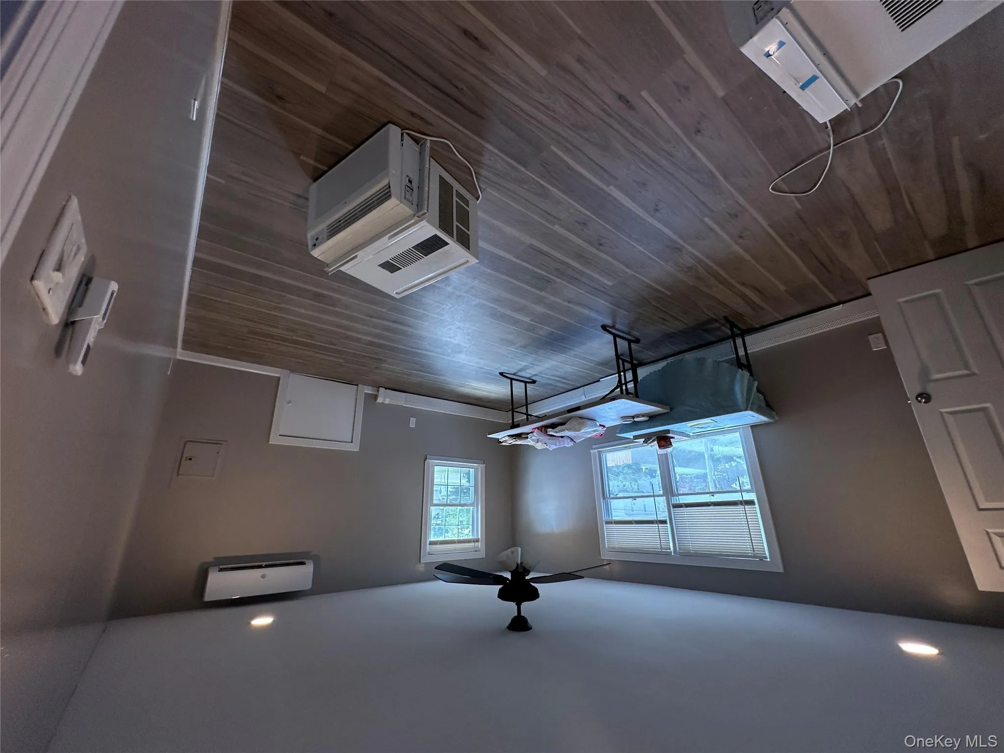 Office space with recessed lighting, dark wood-type flooring, a ceiling fan, and an AC wall unit Office space with recessed lighting, dark wood-type flooring, a ceiling fan, and an AC wall unit