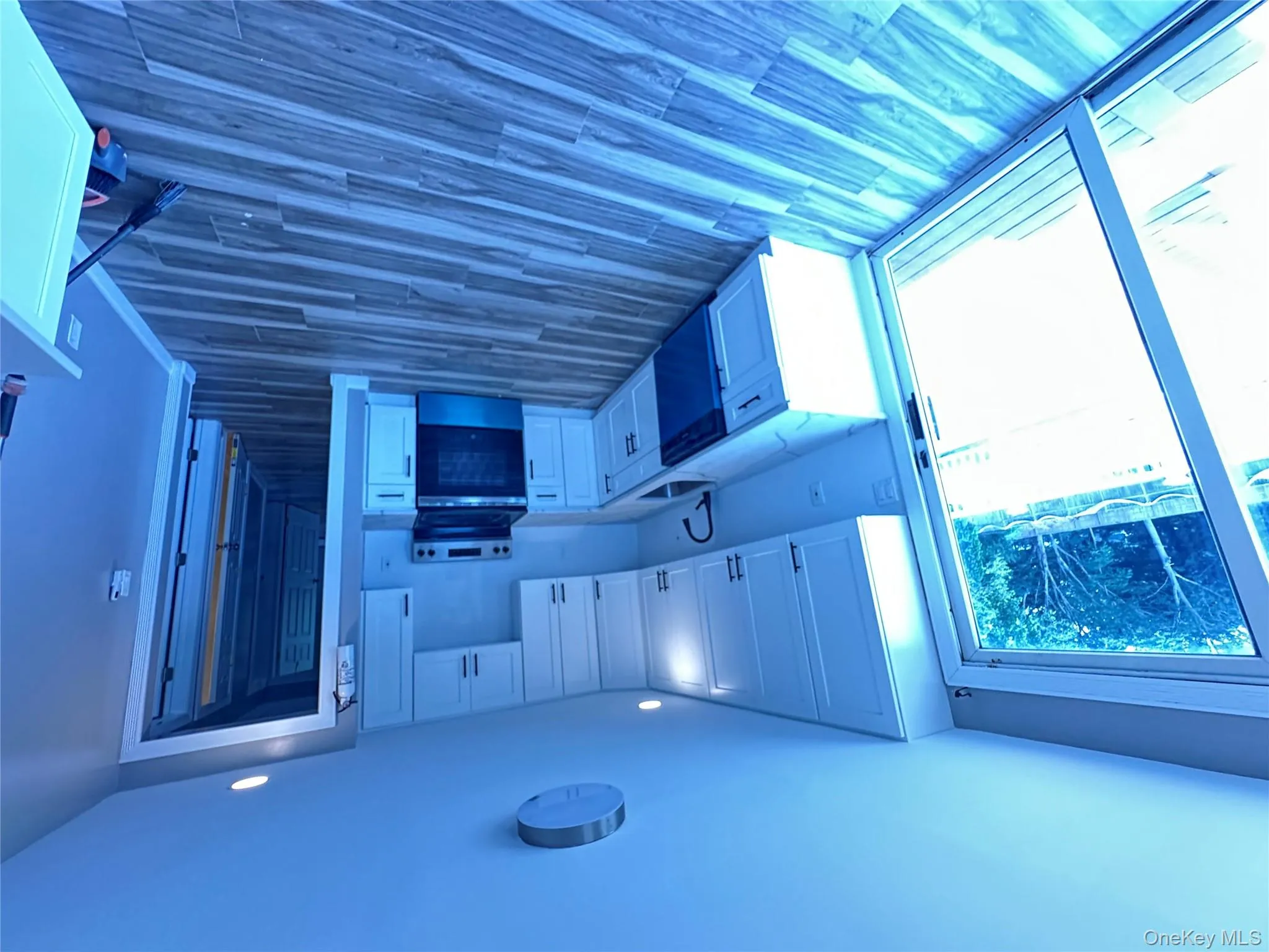 Kitchen featuring white cabinetry, white stove, dark wood-style floors, and recessed lighting Kitchen featuring white cabinetry, white stove, dark wood-style floors, and recessed lighting