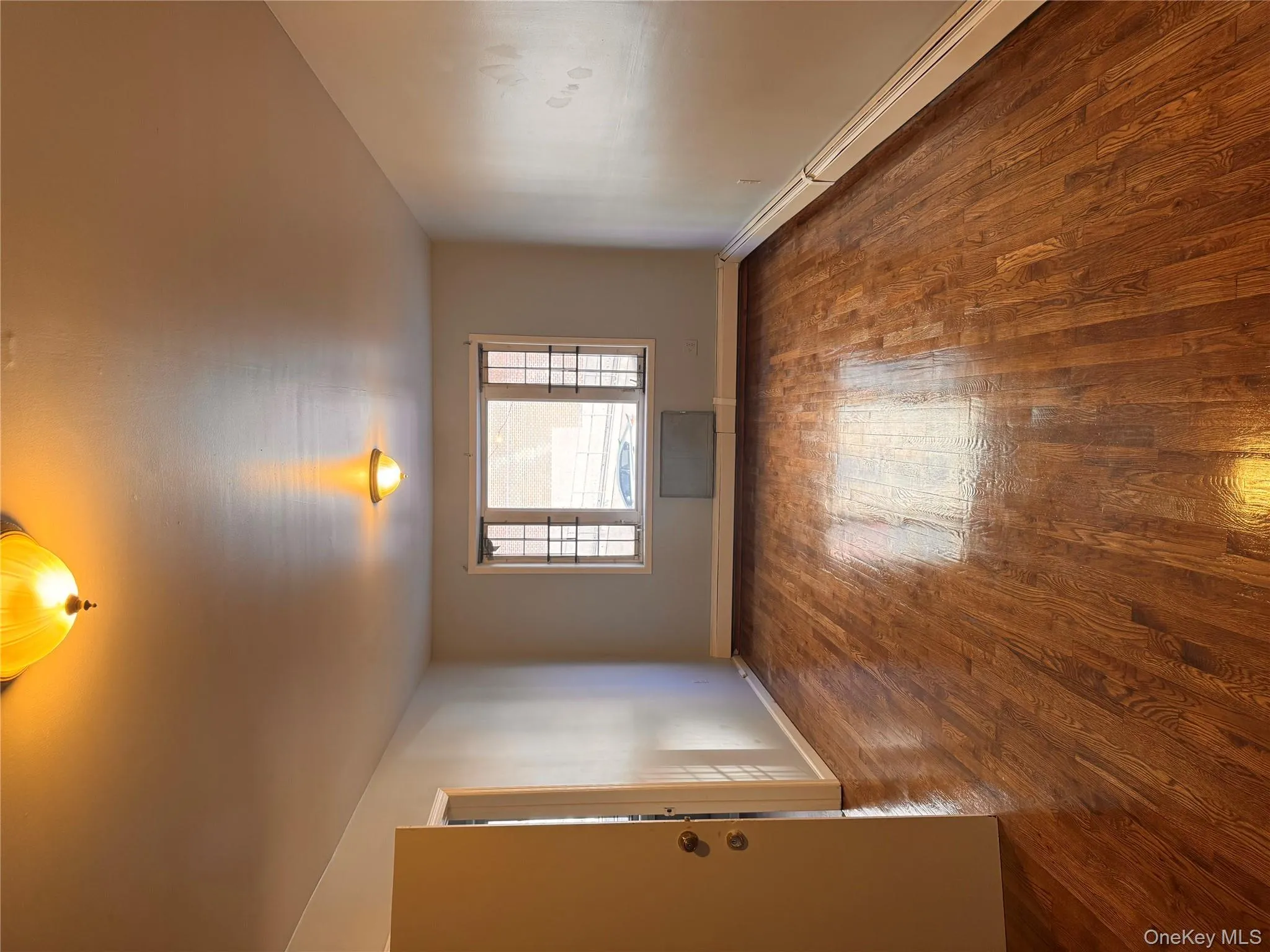 Spare room featuring a baseboard radiator and dark wood-style flooring Spare room featuring a baseboard radiator and dark wood-style flooring