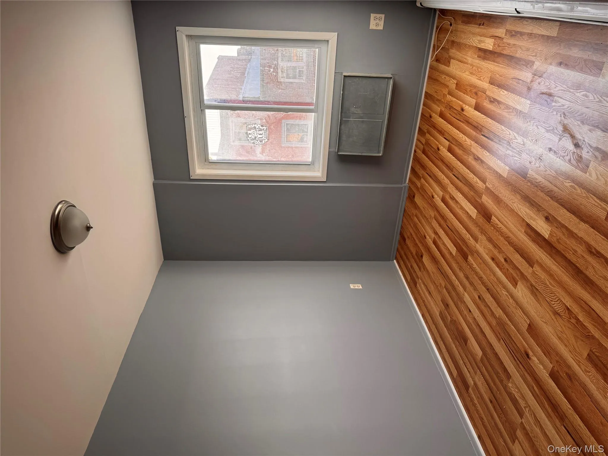 Unfurnished room with light wood finished floors and baseboards Unfurnished room with light wood finished floors and baseboards