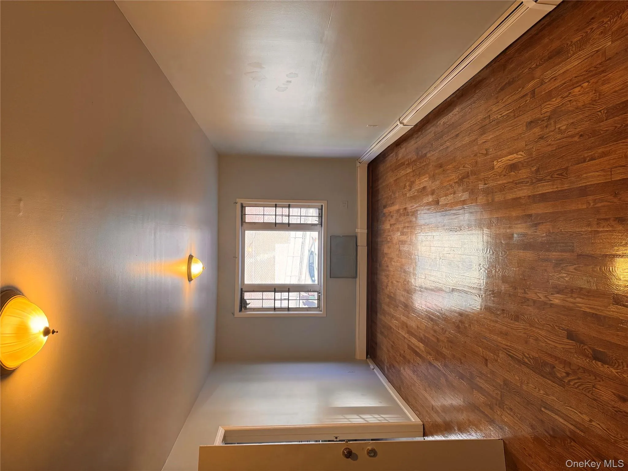 Spare room with a baseboard radiator and dark wood finished floors Spare room with a baseboard radiator and dark wood finished floors