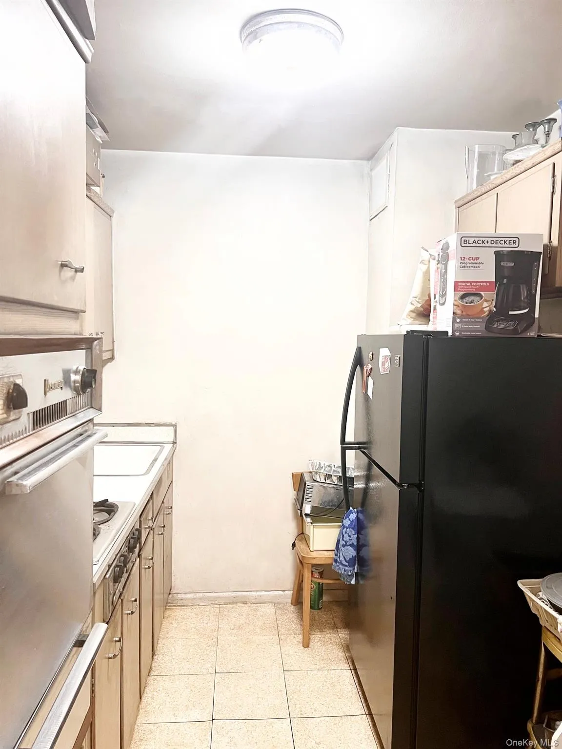 Kitchen with freestanding refrigerator, double oven, and light countertops Kitchen with freestanding refrigerator, double oven, and light countertops