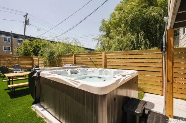 View of yard featuring a hot tub and a patio View of yard featuring a hot tub and a patio