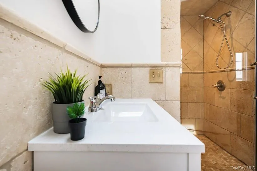 Bathroom with vanity and a tile shower Bathroom with vanity and a tile shower