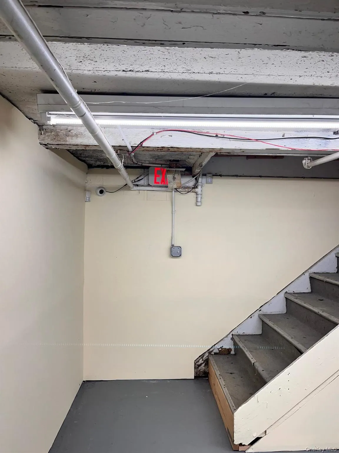 Below grade area featuring stairs Below grade area featuring stairs