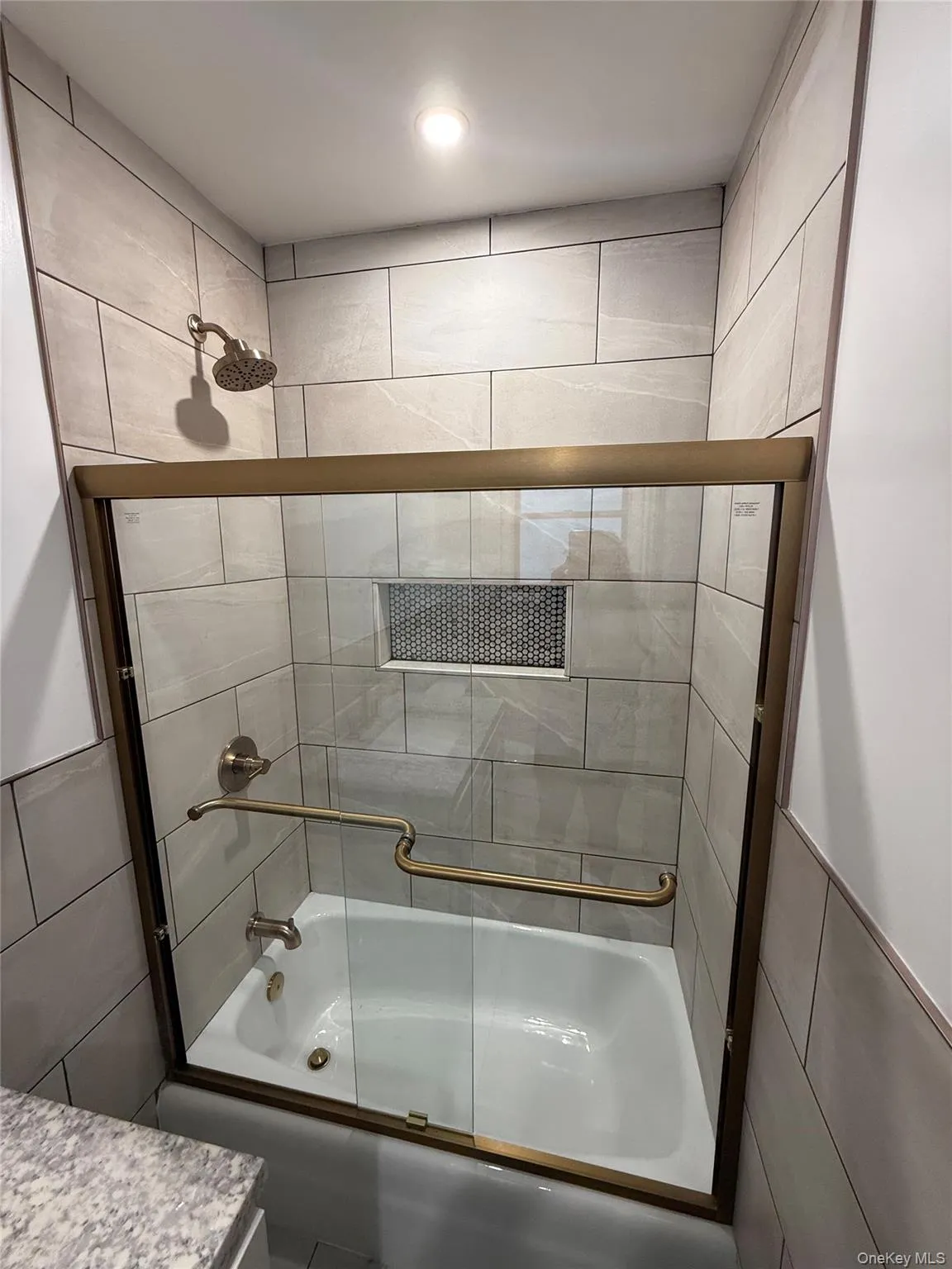 Bathroom featuring shower / bath combination with glass door Bathroom featuring shower / bath combination with glass door