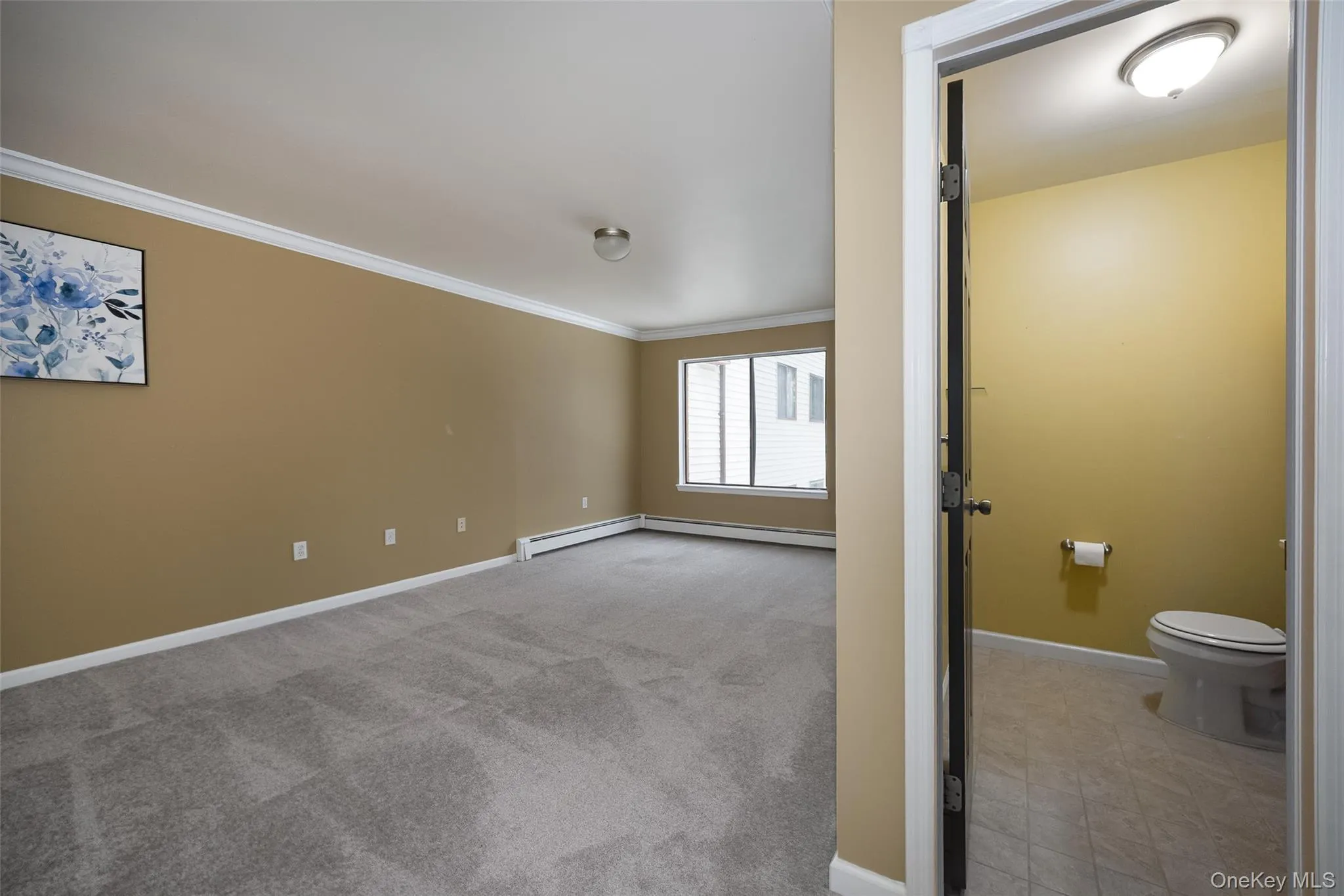 Spacious room featuring an en-suite bath and elegant crown molding Spacious room featuring an en-suite bath and elegant crown molding