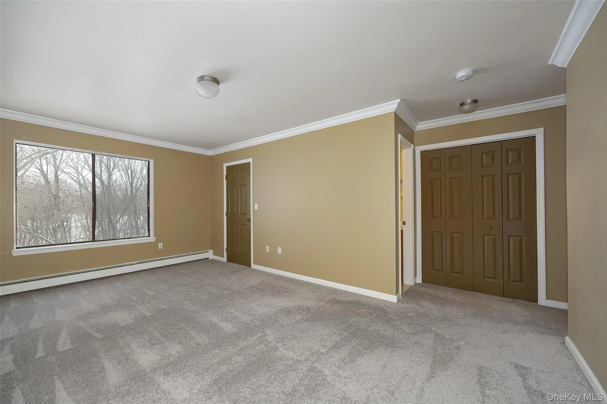 Spacious room featuring an en-suite bath and elegant crown molding Spacious room featuring an en-suite bath and elegant crown molding