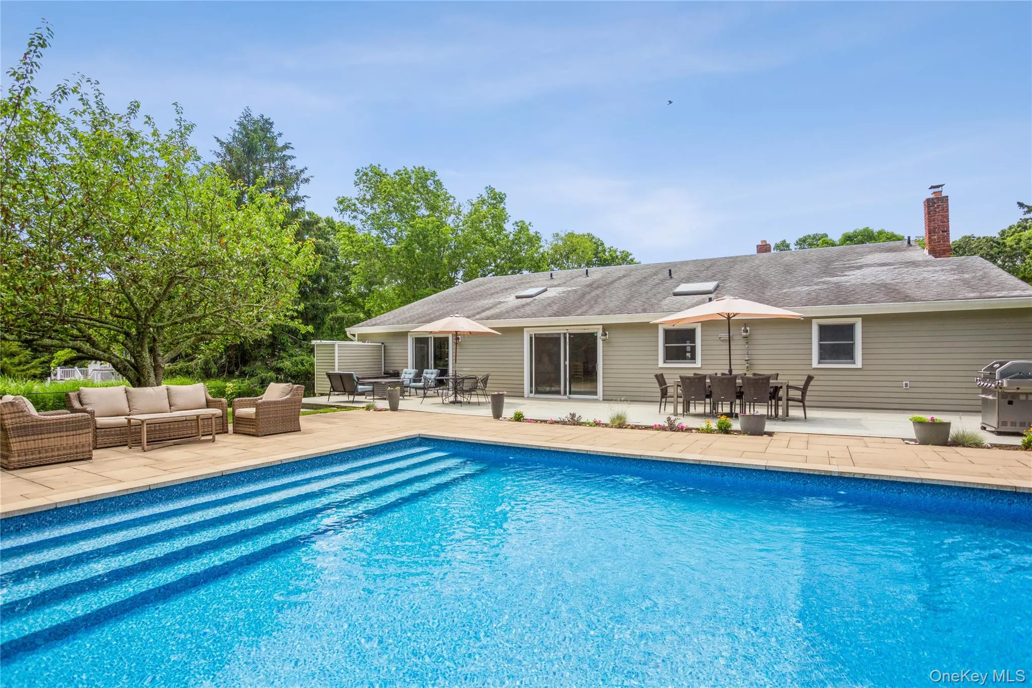 Outdoor pool featuring a patio area, an outdoor living space, outdoor dining space, and grilling area Outdoor pool featuring a patio area, an outdoor living space, outdoor dining space, and grilling area