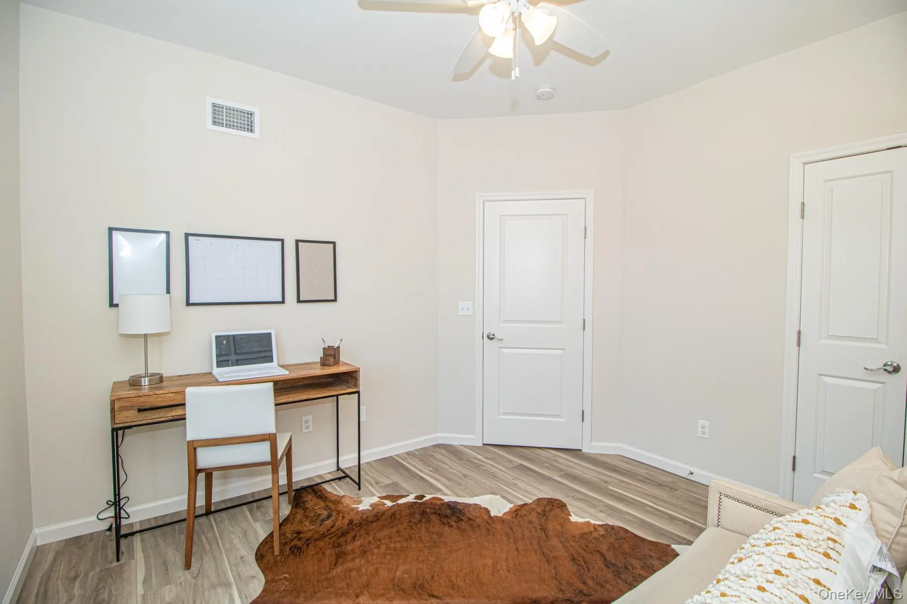 Home office featuring light wood-type flooring and a ceiling fan Home office featuring light wood-type flooring and a ceiling fan