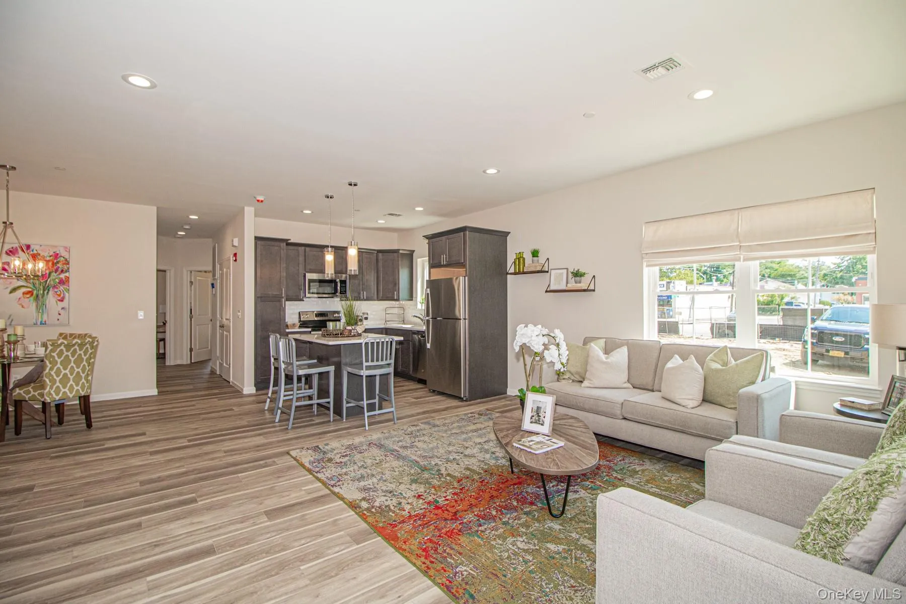 Living room featuring light wood finished floors and recessed lighting Living room featuring light wood finished floors and recessed lighting