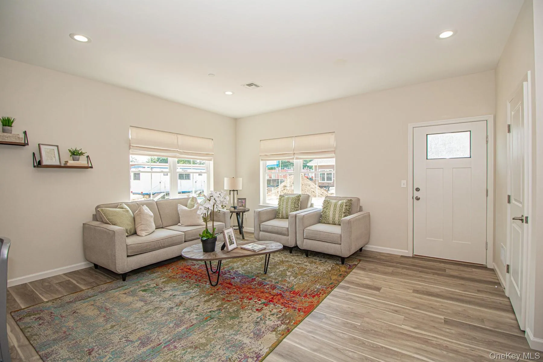 Living area featuring light wood-style flooring and recessed lighting Living area featuring light wood-style flooring and recessed lighting