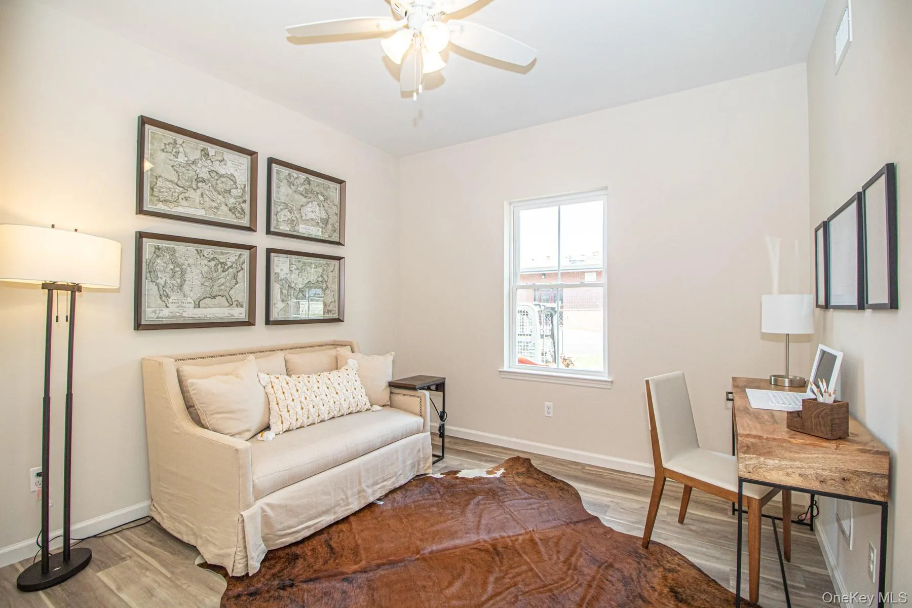 Office with wood finished floors and a ceiling fan Office with wood finished floors and a ceiling fan