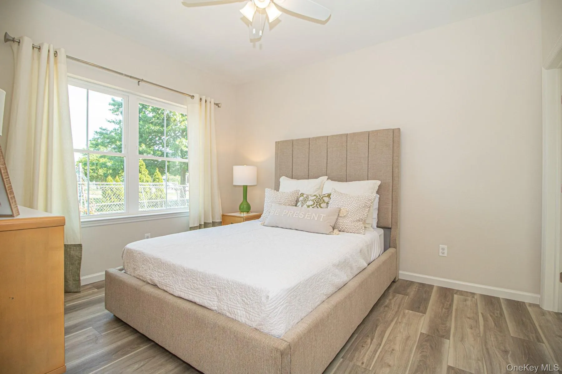 Bedroom featuring wood finished floors and a ceiling fan Bedroom featuring wood finished floors and a ceiling fan