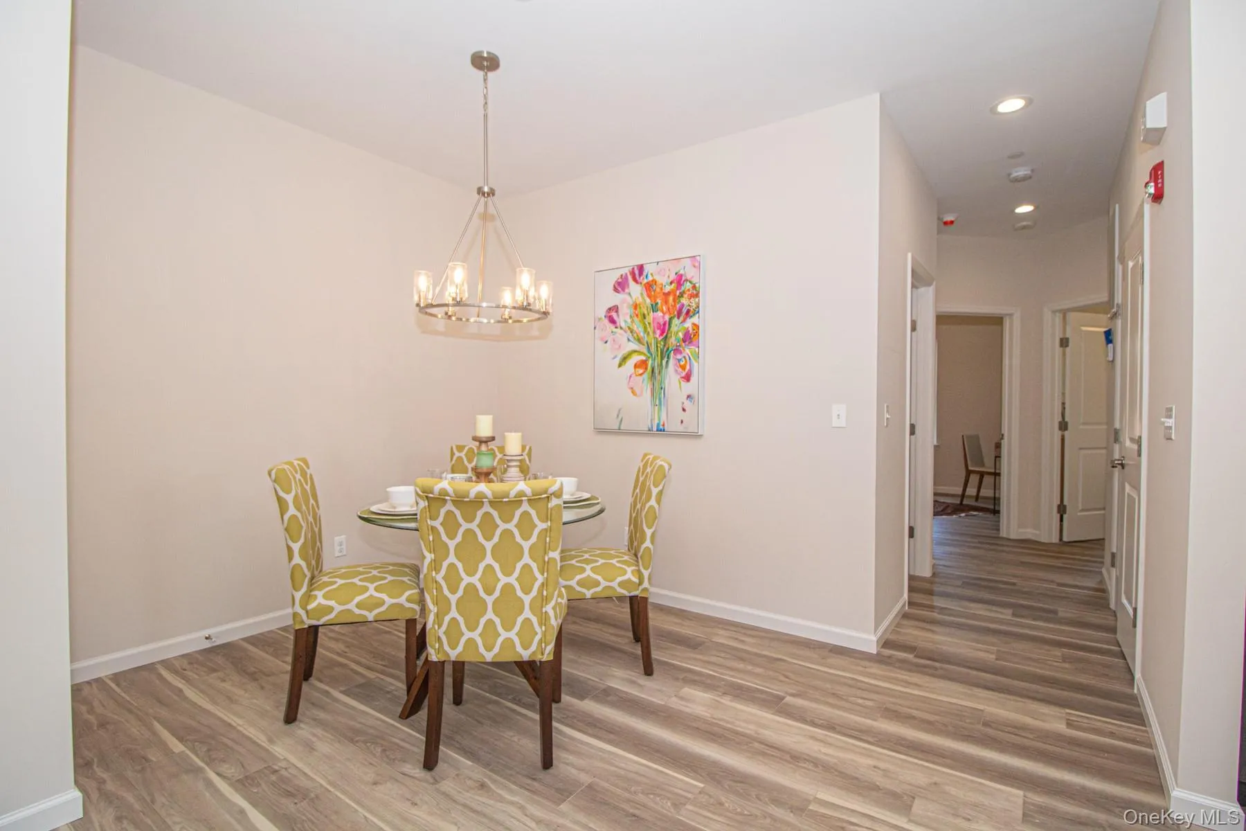 Dining area with light wood-type flooring, a chandelier, and recessed lighting Dining area with light wood-type flooring, a chandelier, and recessed lighting
