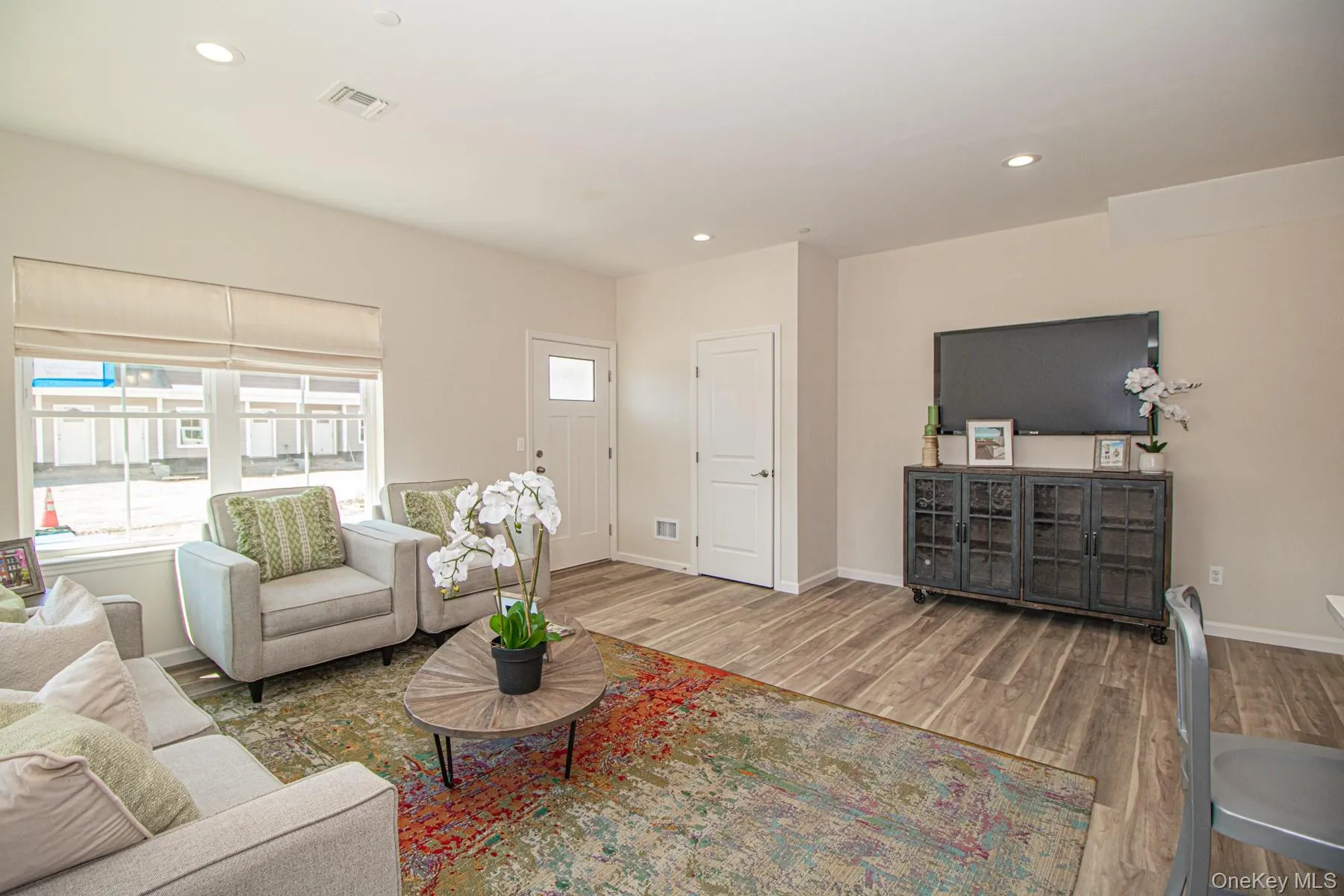 Living area featuring recessed lighting and wood finished floors Living area featuring recessed lighting and wood finished floors