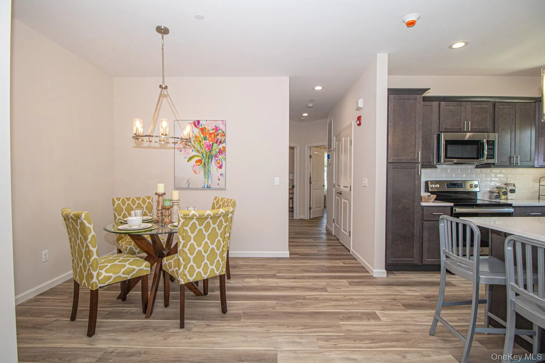 Dining area featuring light wood-type flooring, recessed lighting, and a chandelier Dining area featuring light wood-type flooring, recessed lighting, and a chandelier